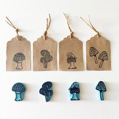 four wooden tags with different types of mushrooms on them