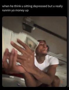 a man holding money up to his face