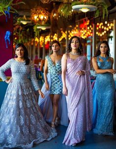 four women in evening dresses posing for the camera