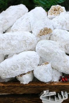 a wooden box filled with white powdered donuts