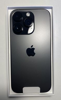 an iphone 11 pro in its box with the camera facing up on it's side