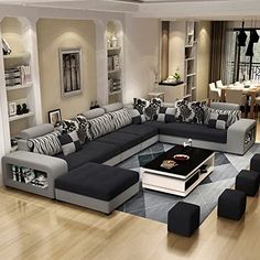 a living room filled with lots of furniture next to a large open floor plan area