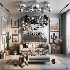 a living room filled with furniture and lots of balloons hanging from the ceiling above it