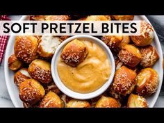 a white plate topped with pretzel bites covered in peanut butter