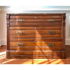 an old wooden chest of drawers in a room with sunlight coming through the window onto the floor