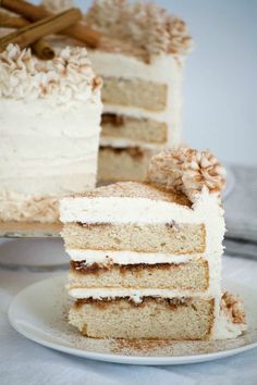 a piece of cake on a plate with another slice in front of it and the rest of the cake behind it