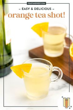 an orange tea shot is garnished with sliced oranges