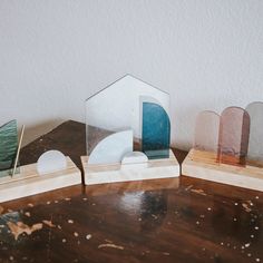 three different shaped objects sitting on top of a wooden table