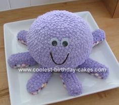 a crocheted purple octopus on a white plate