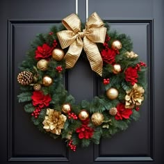 a christmas wreath with gold and red ornaments hanging on a black front door decorated for the holidays