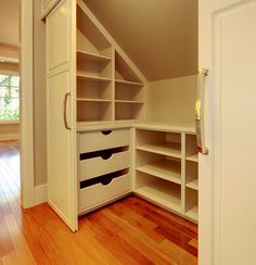 an image of a closet with shelves and drawers