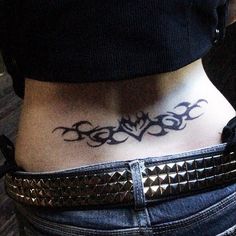 a woman's lower back tattoo with an intricate design on her ribs and bottom