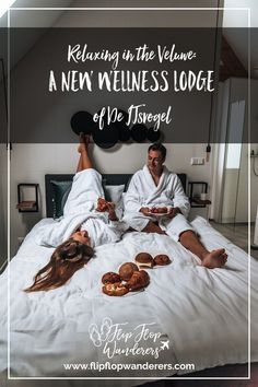 a man and woman laying in bed with food on their feet while they are having a meal