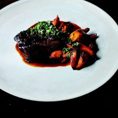 a white plate topped with meat and veggies