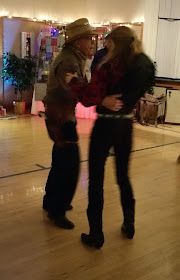 two people are dancing on the dance floor