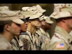 many soldiers are lined up in formation and wearing hats with their faces slightly obscured by the camera