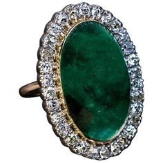 early 1900s This antique 14K gold and silver ring features a cabochon cut emerald (measuring 21.2 x 13 x 9.25 mm) of a nice bluish green color. The emerald is framed by old cushion cut diamonds (H-I color, SI clarity) set in silver over gold. Estimated emerald weight is 19.17 ct. Estimated total diamond weight is 2.20 ct. Ring size 7.25 (18 mm) resizable Simple Diamond Ring, Gemstone Rings Vintage, Vintage Jewellery Rings, Emerald Diamond Ring, Simple Diamonds, Gold And Silver Rings, Jewelry Picture, Cushion Cut Diamonds, Silver Plated Jewelry