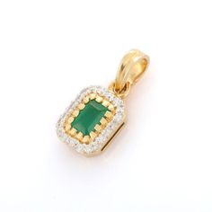 Emerald pendant in 14K Gold. It has a octagon cut emerald studded with diamonds that completes your look with a decent touch. Pendants are used to wear or gifted to represent love and promises. It's an attractive jewelry piece that goes with every basic outfit and wedding too.  PRODUCT DETAILS :-  > Material - 14K Solid Yellow Gold > Gemstone - Emerald  > Stone Weight - 0.62 ct > Stone Shape - Octagon   > Stone Size - 6 x 4 mm > Stone Pcs - 1  > Diamond Weight - 0.2 ct  > Diamond Pcs - 20 > Gross Weight - 1.855 Grams > Setting - Prong setting Emerald Jewelry With Pave Setting For Gift, Emerald Jewelry With Pave Setting As Gift, Octagon Jewelry With Halo Setting In Yellow Gold, Octagon Yellow Gold Jewelry With Halo Setting, Classic Emerald Pendant Necklace With Prong Setting, Emerald Pendant Necklace With Diamond Prong Setting, Octagon Emerald Jewelry With Diamond Accents, Emerald Gemstone Necklace With Rectangular Pendant, Octagon-shaped Emerald Gemstone Jewelry