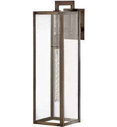 an outdoor wall light with a clear glass panel and metal frame on the front, against a white background