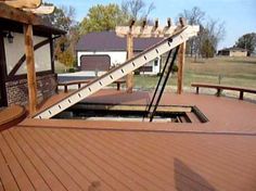 a wooden deck with stairs leading up to the top