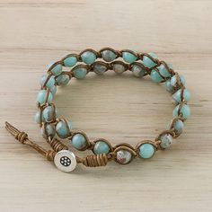 Jasper Beaded Wrap Bracelet in Blue from Thailand - Sky Orbs | NOVICA Hand Wrapped Waxed Cord Bracelets With Round Beads, Handmade Adjustable Spiritual Leather Bracelet, Handmade Spiritual Leather Bracelet With Round Beads, Bohemian Hand Wrapped Beaded Bracelets On Waxed Cord, Adjustable Hand Wrapped Leather Bracelet With Round Beads, Adjustable Hand-wrapped Beaded Leather Bracelet, Bohemian Adjustable Hand Wrapped Leather Bracelet, Handmade Bohemian Wrap Bracelet With Waxed Cord, Adjustable Hand-strung Leather Bracelet With Round Beads