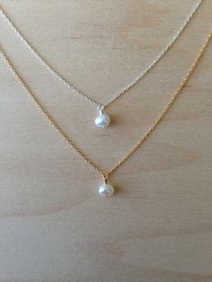 Beautiful. Delicate Lovely 6mm freshwater pearl floats delicately along a 14k Gold Fill chain. Perfect and simple. You can wear it alone for an elegant look or layer it! Also available and photographed with the Silver version, https://www.etsy.com/listing/158536330/pearl-charm-necklace-silver-chain *If you are unsure of the length you need, or would like to wear this item at different lengths, we now offer an adjustable length option! You can add an adjustable end to your necklace using this lin Simple White Pearl Chain Jewelry, Simple White Pearl Necklace For Everyday, Simple White Pearl Drop Necklace, Simple Pearl White Jewelry With Pearl Charm, Simple Pearl Drop Necklace For Gifts, Dainty White Pearl Necklace With Round Pendant, Elegant Tiny Pearl Jewelry, Simple Silver Jewelry With Pearl Chain, Simple White Pearl Necklace As Gift