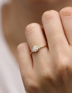 a woman's hand with a diamond ring on it