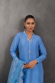 SKU: 1028 Price for Shirt and inner only.This splendid blue ensemble is fabricated on raw silk embellished with alluring sequins, pearls and French knots work giving this piece a perfect oomph. Paired with a gorgeous dupatta adorned with floral work. Blue Cotton Silk Salwar Kameez With Mirror Work, Blue Raw Silk Sets With Mirror Work, Blue Slub Silk Kurta With Sheer Dupatta, Blue Raw Silk Sharara With Mirror Work, Raw Silk Long Sleeve Palazzo Set With Mirror Work, Blue Raw Silk Traditional Wear With Mirror Work, Long Sleeve Raw Silk Palazzo Set With Mirror Work, Blue Raw Silk Dupatta With Mirror Work, Blue Chinon Kurta With Sheer Dupatta