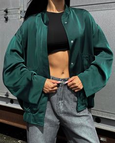 "Emerald green bomber jacket with large patch pockets for a spring fashionable look!  The jacket is made of satin, lined, and fastens with buttons at the front.  The bomber jacket will perfectly complement both your everyday look and for special occasions, parties and more.  DETAILS  - emerald green  - satin  - lined  - button closure  - oversized  - large front patch pockets   SIZES   This bomber jacket is oversized  Back length 29.13\"/ 74 cm Shoulder 8.26\"/ 21 cm Sleeve length 21.25\"/ 54 cm Oversized Green Windbreaker For Spring, Green Oversized Windbreaker For Spring, Green Button-up Outerwear For Streetwear, Trendy Green Utility Jacket For Streetwear, Green Cropped Jacket With Pockets, Green Long Sleeve Cropped Jacket With Pockets, Oversized Green Utility Jacket For Spring, Oversized Green Long Sleeve Utility Jacket, Oversized Green Utility Jacket For Work