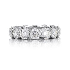 a white gold ring with five round diamonds on the top and bottom, set in 18k white gold