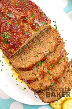 sliced meatloaf on a plate with crackers