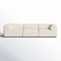 a white couch sitting on top of a white floor