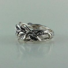 "Material: Sterling Silver 92.5 (shown) Available in 14k Gold Finish Shown: Oxidized (shown and recommended) it just brings out the depth and detail in the ring. Width: 10.5mm or 7/16\" wide I wanted to create a beautiful Twig and Leaf Band, so I sculpted the stems first and then added eight beautiful natural flowing leaves. Similar to the original Leaf and Twig Design, just a bit more weight and no twigs on the edge of the ring. This is a growing line for me, I love going into my studio and jus Silver Fine Jewelry Rings For Marriage, Silver Wedding Flower Ring With Diamond Cut, Nature-inspired Wedding Rings With Prong Setting, Unique White Gold Wedding Ring, Silver Nature-inspired Stackable Rings For Anniversary, Silver Round Flower Ring For Marriage, Sterling Silver Rings For Marriage, Nature-inspired Silver Stackable Rings For Anniversary, Sterling Silver Rings For Wedding, Fine Jewelry