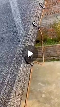 an aerial view of a fence with a video recording device attached to the side of it