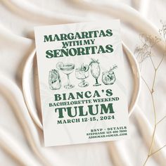 a flyer for margaritas with wine glasses and flowers on a white table cloth next to it