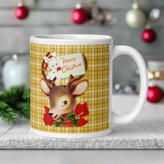 This ceramic glossy coffee mug features a retro vintage illustration of a reindeer wearing a red bow with bells and holly. There is a white bunny sitting in her antlers wearing a santa hat and mittens holding a card that says Merry Christmas. Plaid Ceramic, Retro Reindeer, Coffee Cups Unique, Merry Christmas Reindeer, Bunny Christmas, Plaid Background, Reindeer Decorations, Christmas Coasters, Hot Chocolate Mug