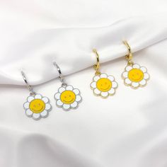 "This listing is for one pair of rhodium plated (silver color) or gold plated smiley face daisy flower charm earrings with mini huggie hoops. Earrings are about 1\" in total length." Daisy Shaped Earrings For Summer, Daisy-shaped Earrings For Summer, Trendy Everyday Flower Earrings, Trendy Silver Flower Drop Earrings, Trendy Nickel-free Dangle Flower Earrings, Everyday Daisy Earrings, Trendy Smiley Face Jewelry For Summer, Y2k Gifts, Grunge Jewelry