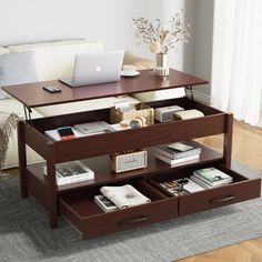 a coffee table with two drawers and a laptop on it in front of a couch