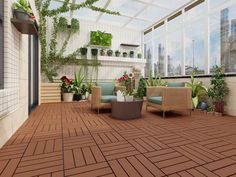 a living room filled with lots of furniture and plants on top of a wooden floor