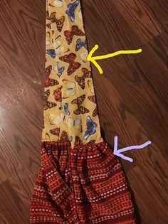 an apron made out of fabric with scissors on the side and yellow string attached to it