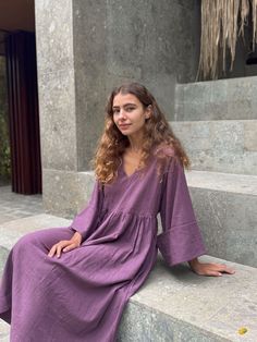 The Purple Gathered Dress, created in collaboration with Erica Kim, features a beautiful shade of purple, carefully crafted by our artisans to complement all skin tones. Its oversized silhouette and roll-up sleeves add a relaxed, effortless vibe, while the gathered waist and V-neckline introduce a subtle touch of femininity. This versatile piece offers a perfect balance of comfort and style, making it a standout addition to your wardrobe. Purple Oversize Roll-up sleeve 100 % Handwoven Organic Co Purple V-neck Dress With Relaxed Fit, Purple Loose Fit Dress For Spring, Purple Relaxed Fit Dress For Spring, Relaxed Fit Purple V-neck Dress, Casual Long Sleeve Dresses With Natural Dye, Purple Spring Loungewear Dress, Purple Loungewear Dress For Spring, Erica Kim, Shade Of Purple