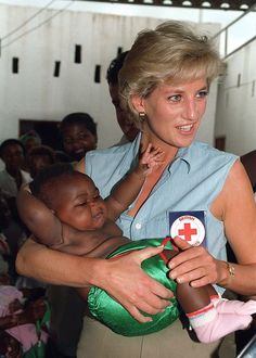 a woman holding a baby in her arms