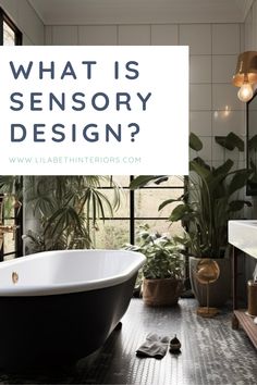 a bath tub sitting next to a window in a bathroom with plants on the floor