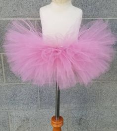 Sparkle, shimmer, twirl and spin,This tutu's where the fun begins,For dress up, play, or just because,All for the little girl you love.This beautiful tutu is made with Mauve colored tulle!!Our tutu band's are made from a crocheted material. They are quite stretchy and will fit from newborn up to a 24" waist.To measure start at the belly button and go around the waist.You may choose from 6" length to 13" length. The shorter the length the fluffier it will be.  Here are the lengths we would sugges Playful Tulle Tutu Dress For Birthday, Pink Tulle Petticoat For Dance, Pink Fairy Tutu Dress For Summer, Princess Tulle Tutu Dress For First Birthday, Pink Fairy Style Tutu Dress For Summer, Princess Style Tulle Tutu Dress For First Birthday, Whimsical Tulle Tutu Dress For First Birthday, Party Tulle Tutu Dress In Balletcore Style, Balletcore Tutu Party Dress With Tulle Skirt