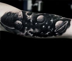 a man's arm with planets and stars on it