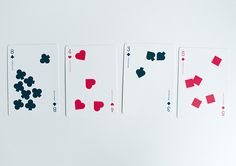 four playing cards with different shapes and colors