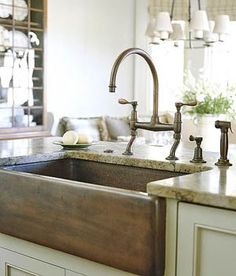 a kitchen sink with two faucets in it