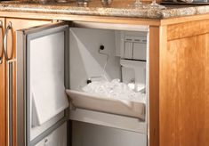 a kitchen sink with ice and water in the bottom drawer, next to a counter