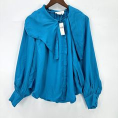 Anthropologie Blouse Womens Long Sleeve Button Down Asymmetrical Blue S Nwt Blue Asymmetrical Hem Blouse For Fall, Blue Asymmetrical Blouse, Summer Asymmetrical Tops With Button Closure, Asymmetrical Summer Tops With Button Closure, Spring Blouse With Asymmetrical Hem And Button Closure, Asymmetrical Blue Blouse For Workwear, Asymmetrical Blue Blouse For Work, Blue Asymmetrical Hem Blouse For Spring, Spring Asymmetrical Tops With Button Closure