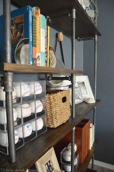 a bookshelf with baseballs and other items on it in a room that has blue walls